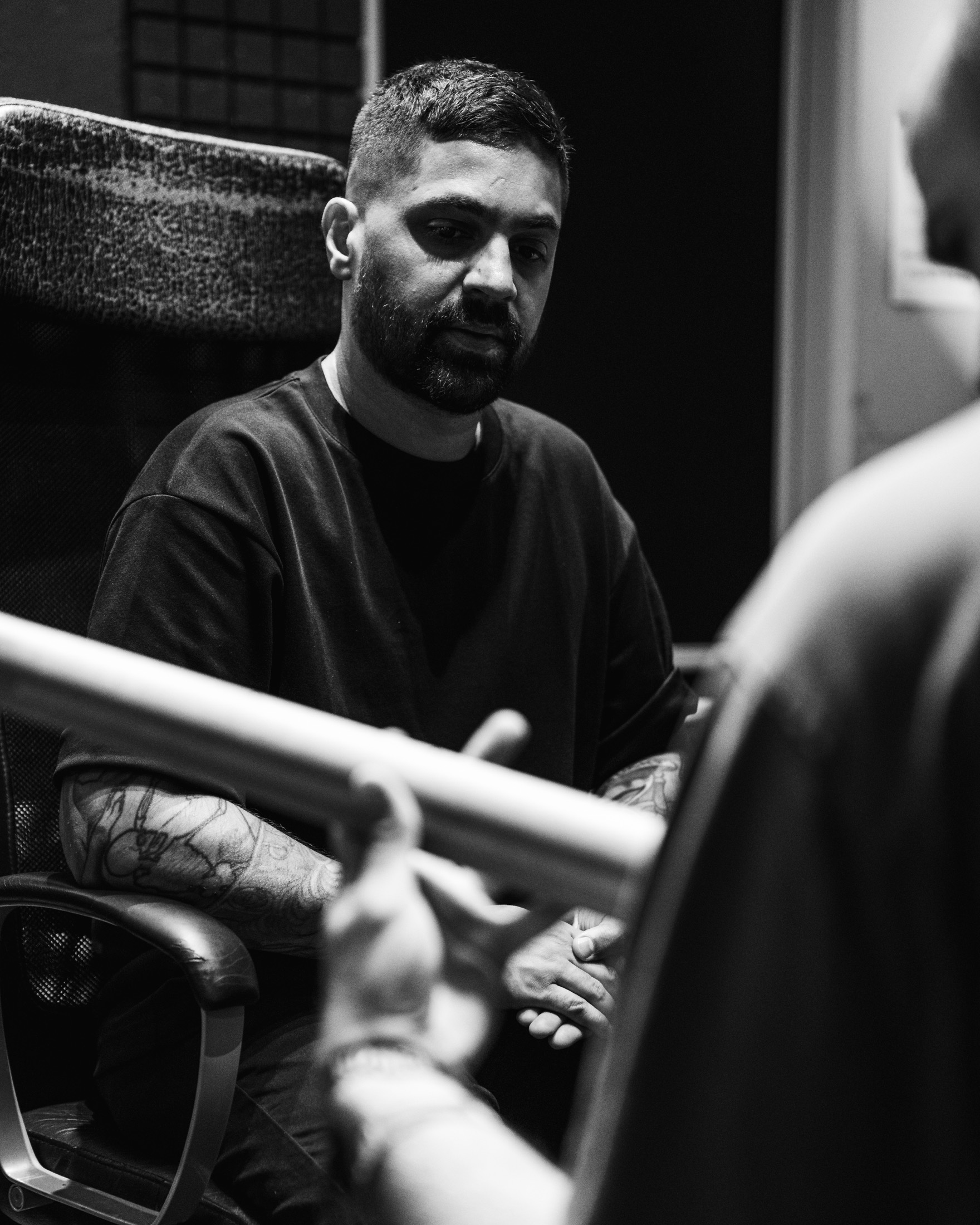 Imran Siddiqi listening to an artist during a studio session
